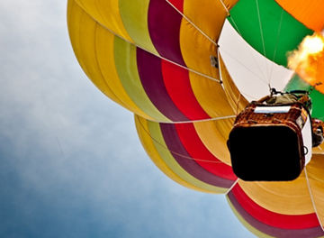 Colourful hot air balloon flying in sky.