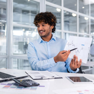 Portrait successful businessman, Latin American man shows a report of financial documents online interlocutors in the laptop screen, an employee inside an office building online video conference.