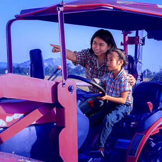 Lady and daughter on tractor farm