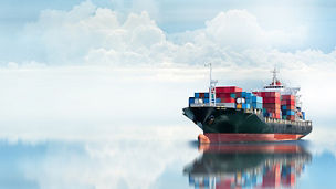 Huge cargo ship against clouds