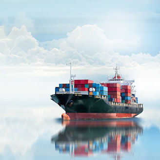 Huge cargo ship against clouds