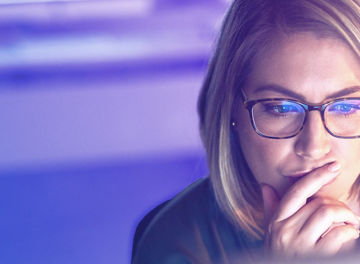 Outdoor shot of young woman using mobile phone outdoors in the city. Female business professional using smart phone in the city.