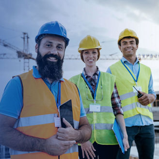 A diverse team of engineers on site in protective clothing