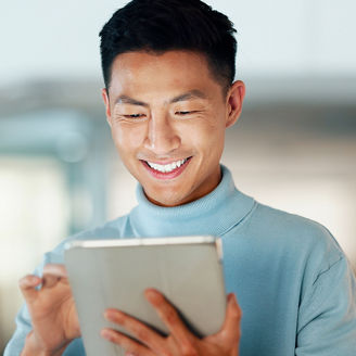 Asian man with tablet, smile and scroll, thinking and reading email, review or article at startup. Internet, research and happy businessman with digital app for with networking, social media or web