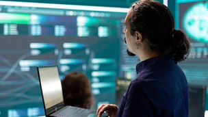 Cyber security team investigates governmental hacking malware attack on internet servers, high tech office. Cybercriminals hack computer systems, threatening account database protection.