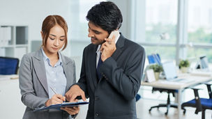 man in suit talking phone