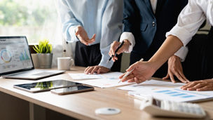 Team work process. Marketing strategy brainstorming. Paperwork and digital in modern office