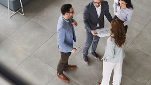 overhead shot of a group of business people chatting in reception area