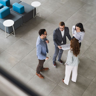 overhead shot of a group of business people chatting in reception area