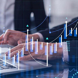 Person typing on laptop with graphs overlaid, representing actuarial transformation