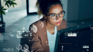 Data analyst looking at graphs on-screen