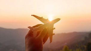Hand holding toy plane