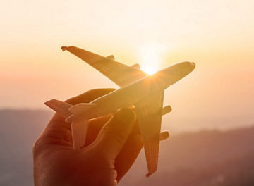 Hand holding toy plane