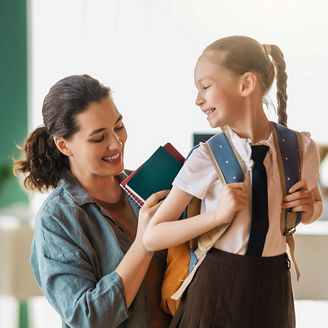 Mother prepares child for back to school