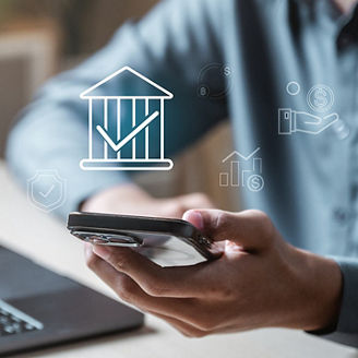 Hand holding smartphone with banking icons overlaid