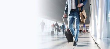 Man walking through airport with bags