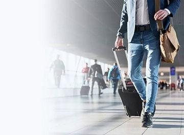 Man walking through airport with bags