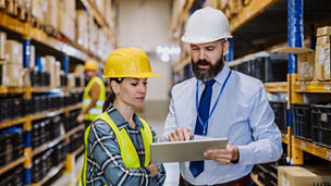 Manager explaining work to his employers in warehouse representing employment taxes in Budget 2027