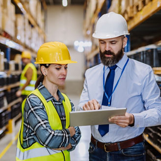 Manager explaining work to his employers in warehouse representing employment taxes in Budget 2027