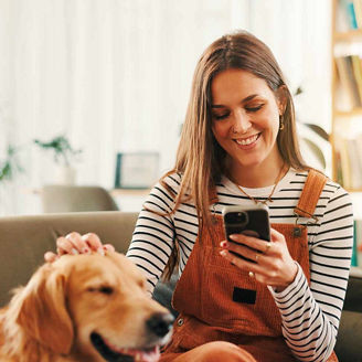 Phone, relax and woman on sofa with dog for bonding representing Budget 2027 headlines