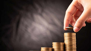 Mutual fund or systematic investment plan concept, putting coin on coin stack representing budget 2027 investment account