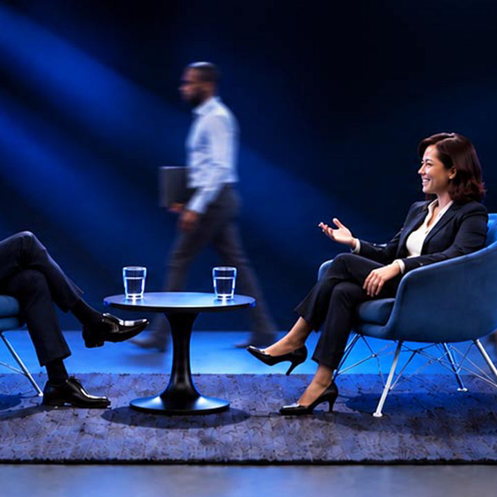 2 executives in conversation on a stage representing CEO Outlook 2026