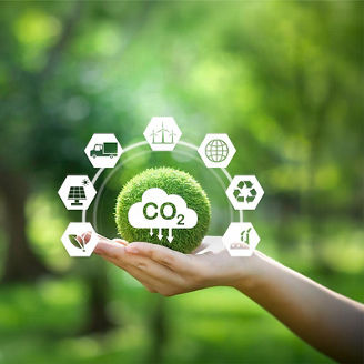 Hand holding ball of grass with CO2 overlaid, representing greenhouse gas accounting