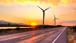 Wind turbines at sunset representing energy transition and resilience