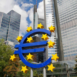 Euro sculpture in the city of Frankfurt, with the Euro Tower in the background