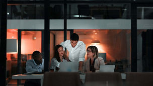People in business meeting after dark representing financial services