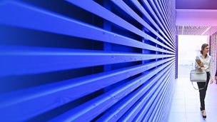 Two people walking in corridor