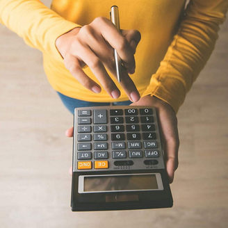 Person using calculator, seen from above