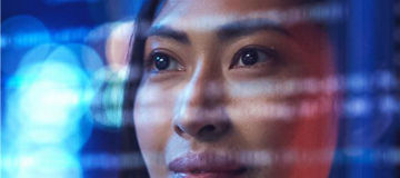 Woman looking at code on screen