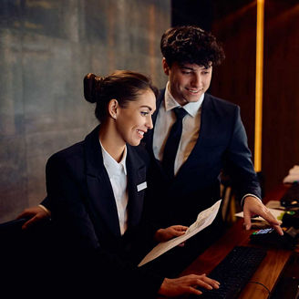 Two people working in hotel reception