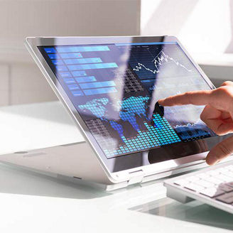 Hands pointing to screen and typing on keyboard