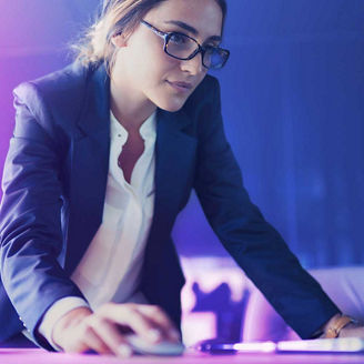 Woman working on laptop representing IFRS 18: Corporate Treasury perspective
