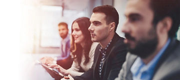 Four people watching a presentation