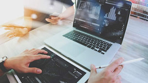 Hands typing on laptop