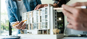 Group of engineer is discussion and brainstorming about condominium model of construction project.