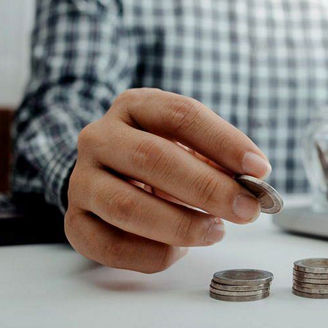 Two people discussing money with coins in jars
