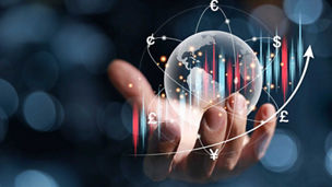 Hand holding transparent globe surrounded by currency symbols and upward graph