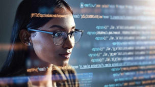 Woman looking at code representing regulatory reporting and governance