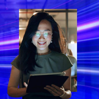 Smiling woman in spectacles looking at an ipad