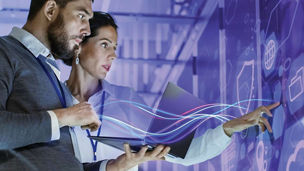 Two people looking at interactive wall