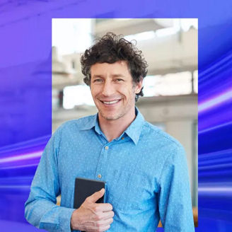 Man smiling and holding tablet