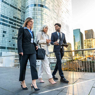 3 people walking in financial district representing financial services