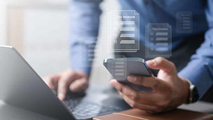 Person using phone and laptop to calculate representing indirect tax