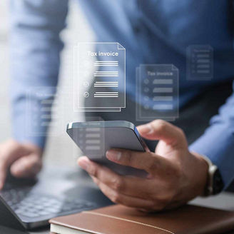 Person using phone and laptop to calculate representing indirect tax