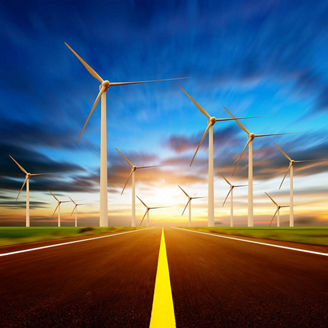 Wind power stations and highway at sunset time representing Utilities Regulatory and Transformation