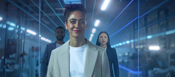 3 people in office with neon lines overlaid